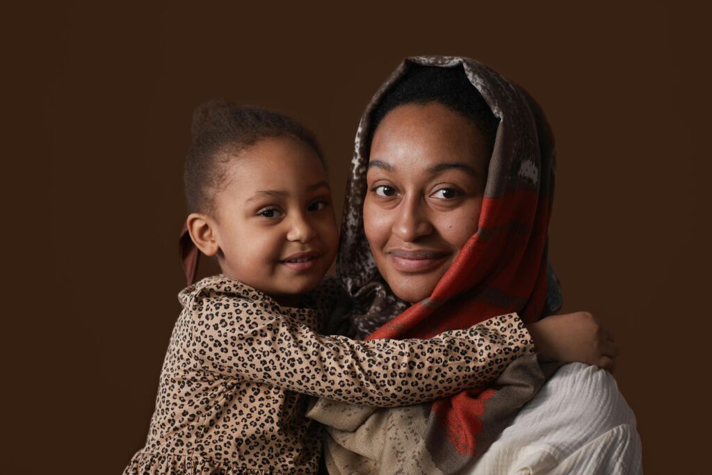 A beautiful studio portrait of a mother and child sharing a warm embrace, expressing love and connection.
